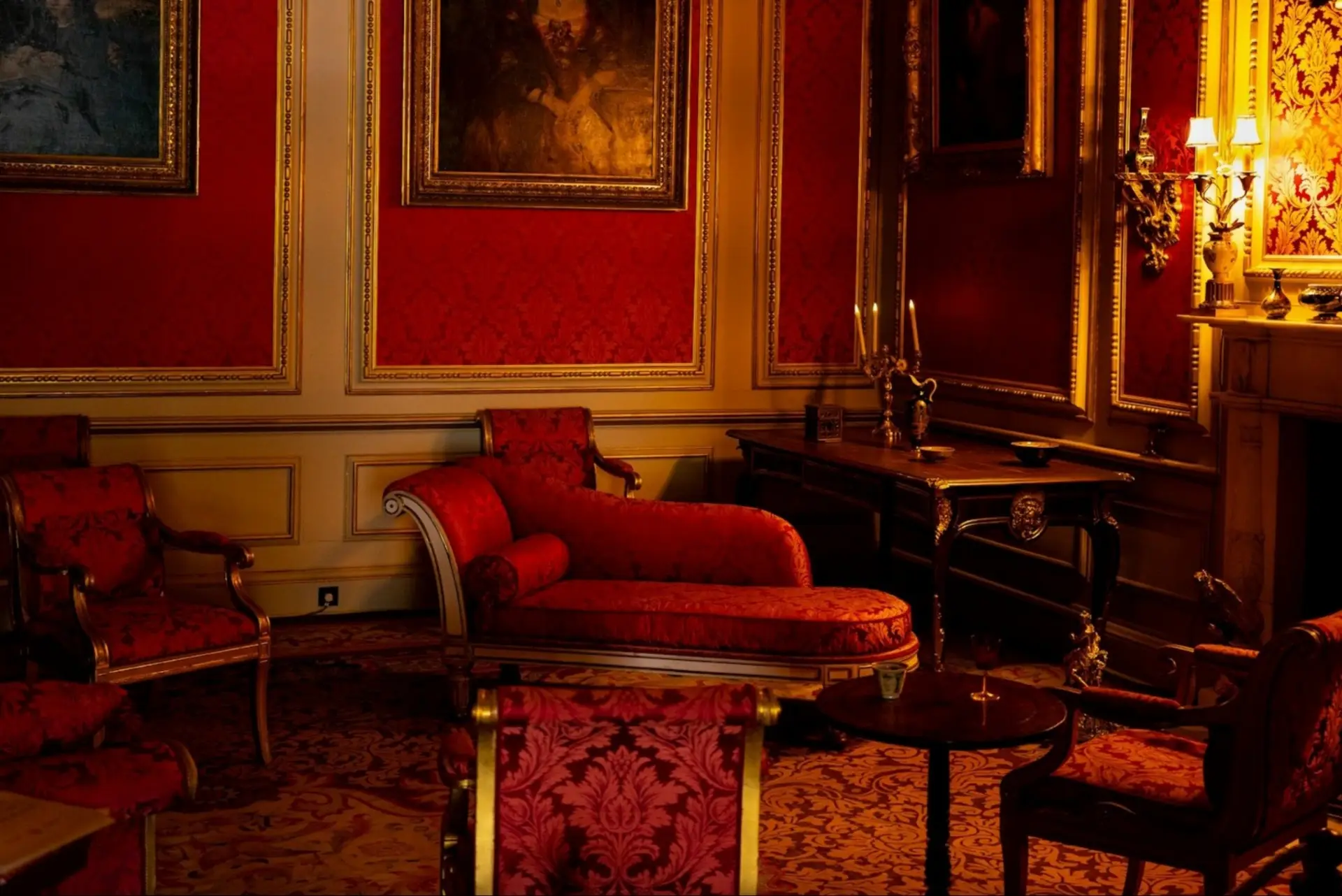 A room with old-fashioned furniture and red decor