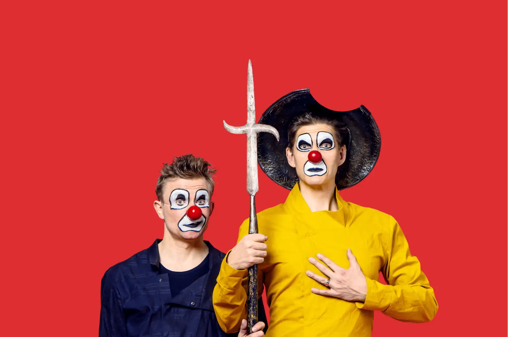 Two clowns are looking at the camera