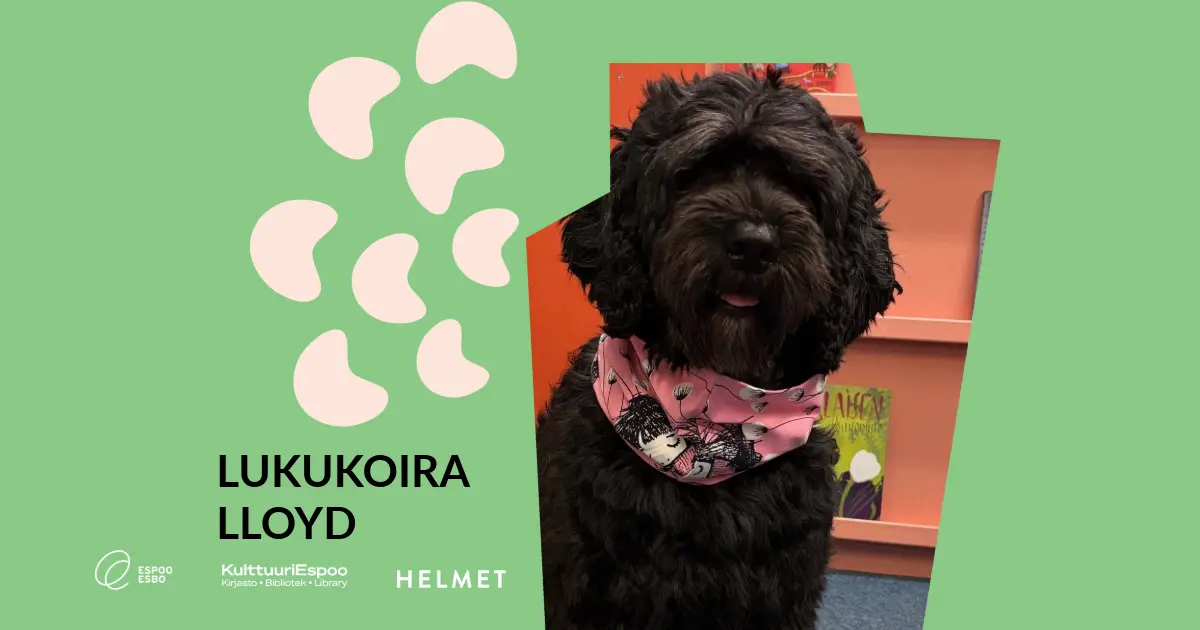 Musta koira jolla on kaulassa pinkki bandana -huivi. Nimi: Lukukoira Lloyd